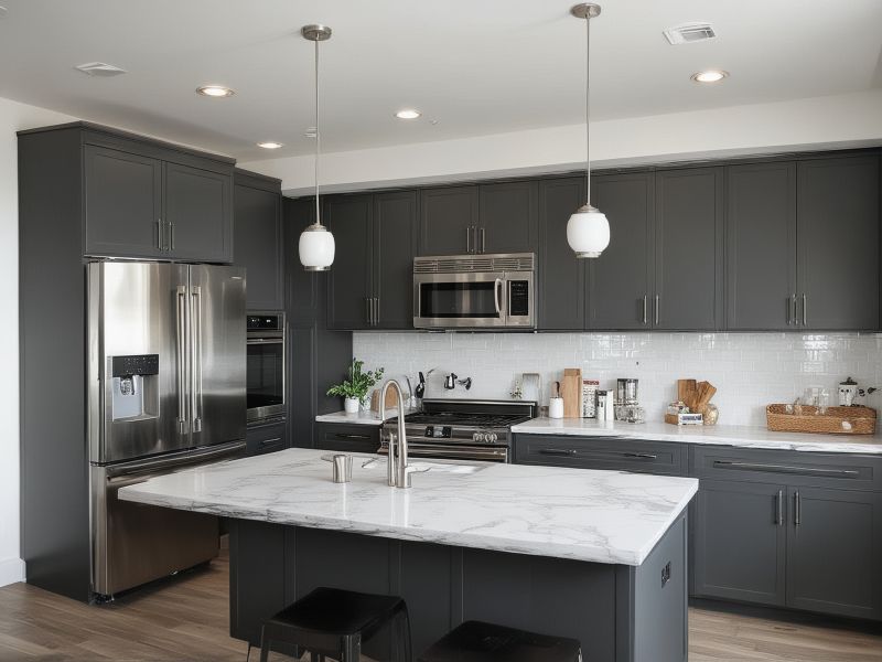 Modern kitchen with gray cabinets, white countertops, and stainless steel appliances